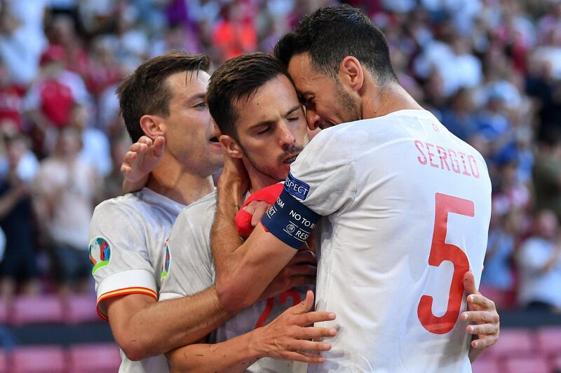 Spain midfielder Pablo Sarabia, centre, celebrates with teammates after scoring their opening goal.