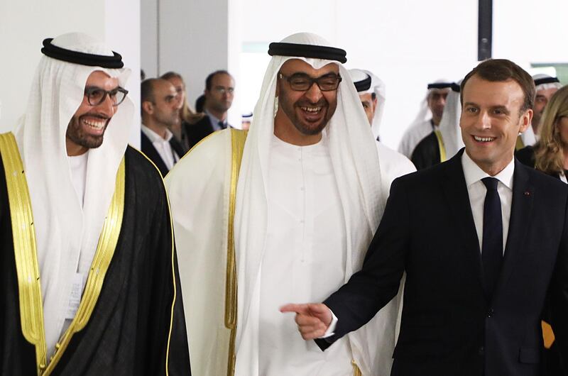 (From L to R) Chairman of Abu Dhabi's Tourism and Culture Authority, Mohamad Khalifa al-Mubarak, Abu Dhabi Crown Prince Mohammed bin Zayed Al-Nahyan and French President Emmanuel Macron laugh as they visit the Louvre Abu Dhabi Museum on November 8, 2017 during its inauguration on Saadiyat island in the Emirati capital. / AFP PHOTO / ludovic MARIN