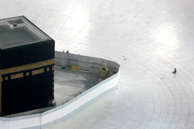 A Saudi policeman prays in front of the Kaaba, the cubic building at the Grand Mosque, in the Muslim holy city of Mecca, Saudi Arabia. AP Photo