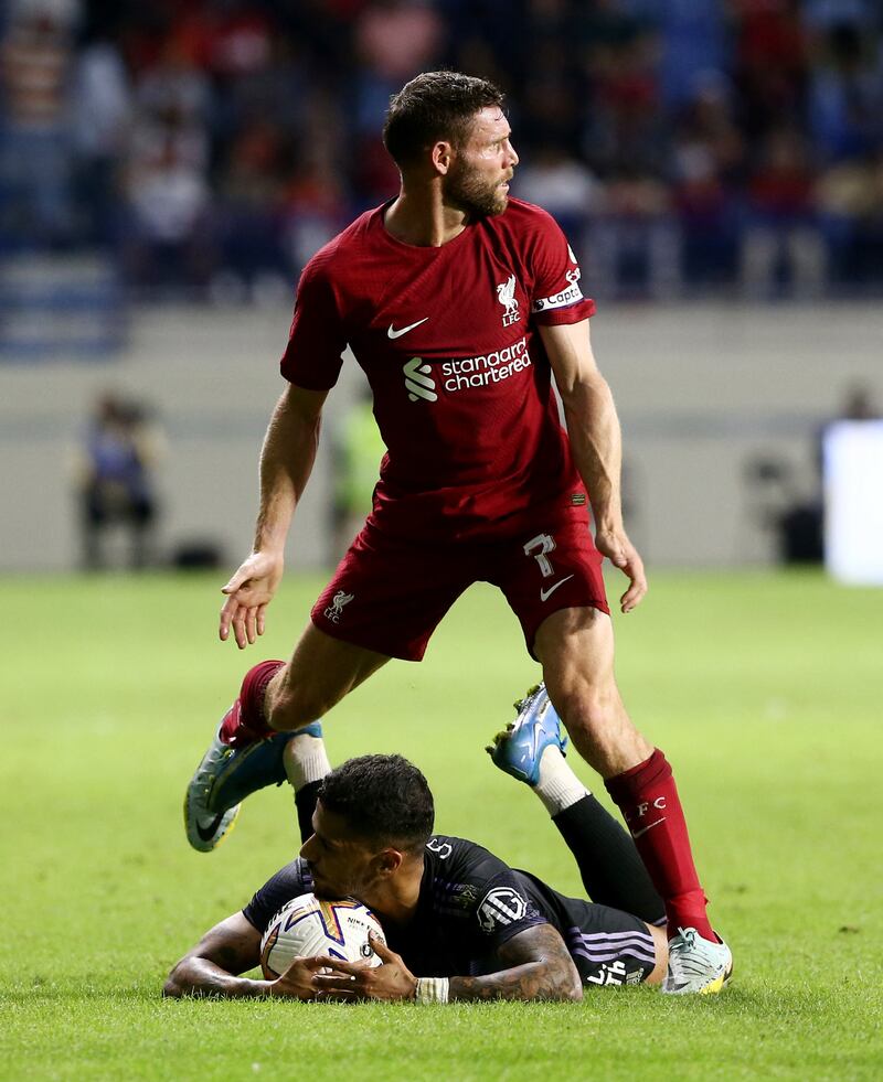 Lyon's Henrique in action with Liverpool's James Milner. Reuters