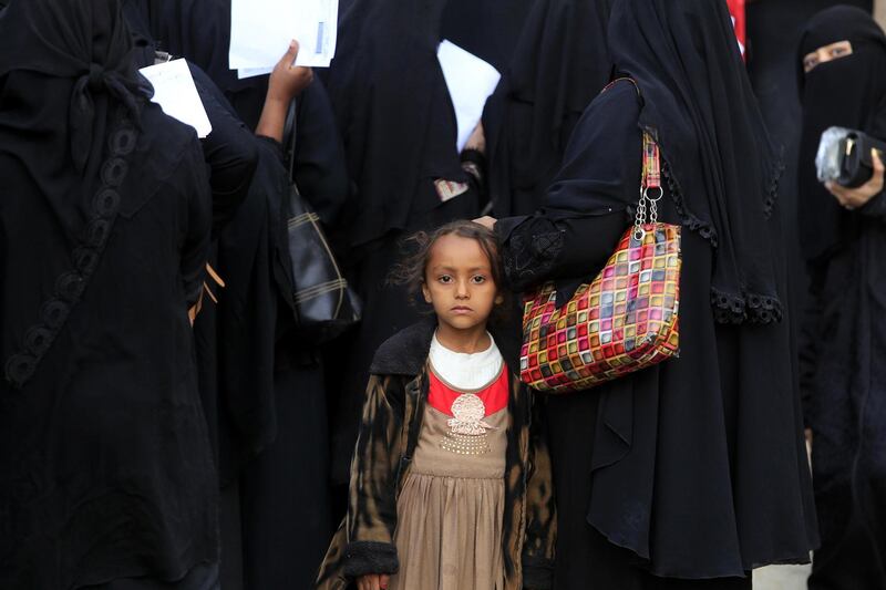 A child stands among displaced people gathering to register at an evacuation centre in Sana'a, Yemen. EPA