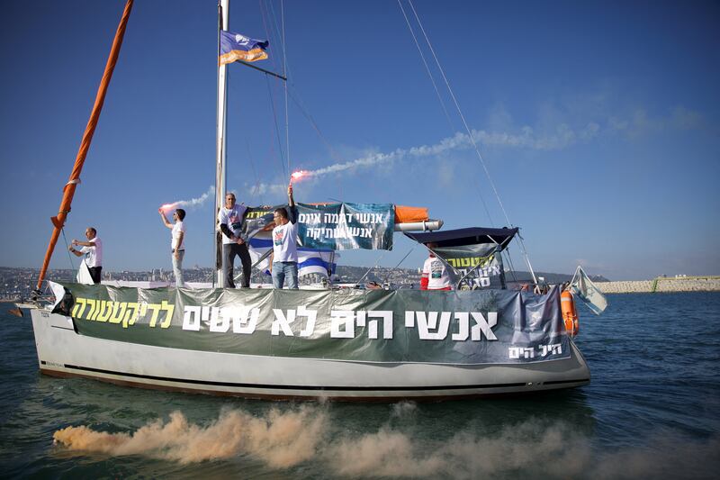 Israeli naval reservists and volunteers in Haifa use flares to demonstrate during the Day of Resistance. Reuters