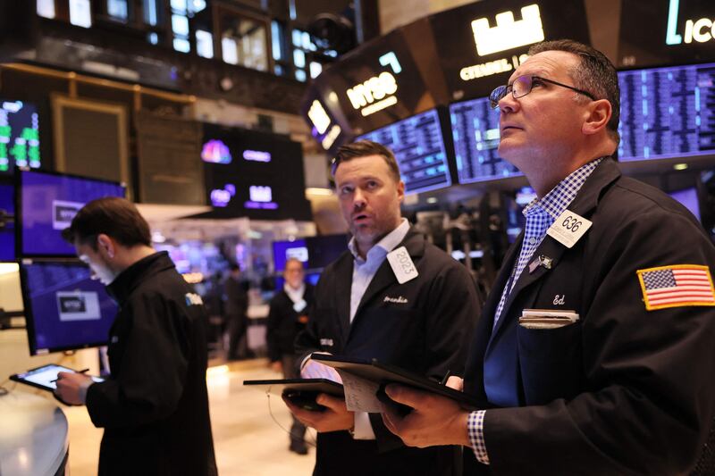 Traders at the New York Stock Exchange after Credit Suisse shares fell more than 25 per cent, on March 15. The Dow Jones opened more than 600 points lower. AFP