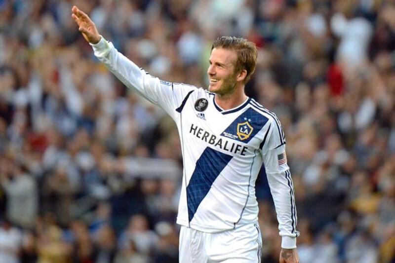 David Beckham waves to fans as he walks off the pitch after the Los Angeles Galaxy defeat the Huston Dynamo in the Major League Soccer (MLS) Cup, December 1, 2012 in Carson, California. It was Beckham's last game with the Galaxy. AFP PHOTO / Robyn Beck