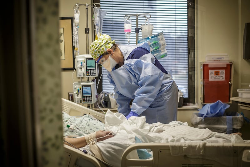 A registered nurse works with a Covid-19 patient inside the infectious disease unit (IDU) at Helen Keller Hospital in Sheffield, Alabama. AP