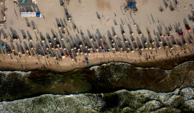 Palestinians sunbathing on a beach in Gaza City on a hot summer day. AFP