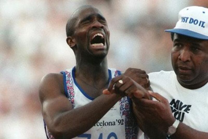 Derek Redmond, the British athlete, is helped by his father after tearing a hamstring during the 400-metre semi-final at the 1992 Barcelona Olympics which left him in tears, but determined to finish.