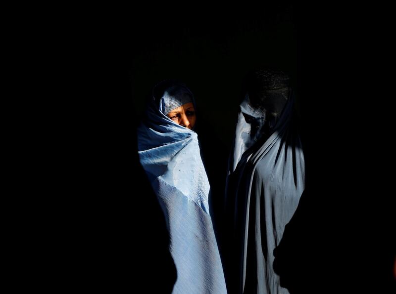 Afghan women wait to cast their votes during a parliamentary election at a polling station in Kabul, Afghanistan. Reuters