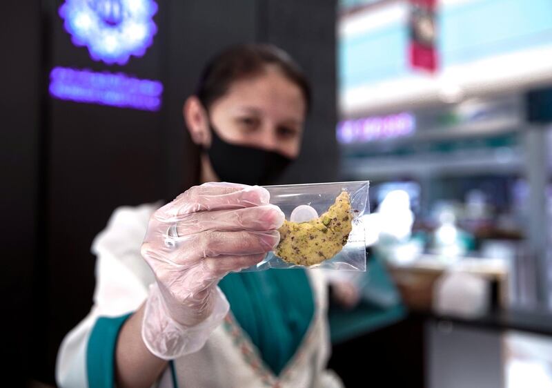 Abu Dhabi, United Arab Emirates, May 18, 2020.    
A Moreish Sweets saleslady with some Ramadan sweets at the Al Raha Mall reopening during the Covid-19 pandemic.
Victor Besa / The National
Section:  NA
Reporter: