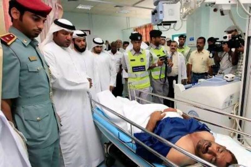 Sharjah Medical Zone officials visit a heatstroke victim at Kuwait Hospital.