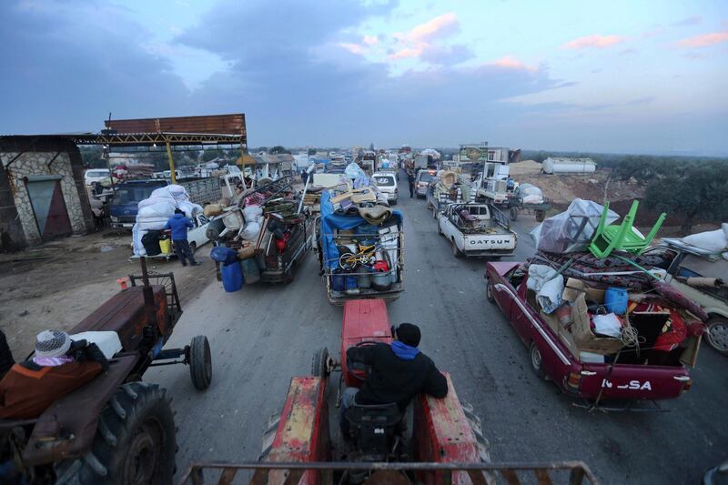 Truckloads of civilians flee a Syrian military offensive in Idlib province on the main road near Hazano, Syria, Tuesday, Dec. 24, 2019. Syrian forces launched a wide ground offensive last week into the northwestern province of Idlib, which is dominated by al-Qaida-linked militants. The United Nations estimates that some 60,000 people have fled from the area, heading south, after the bombings intensified earlier this month. (AP Photo/Ghaith al-Sayed)