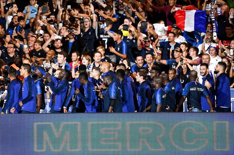 France's team players celebrate with supporters during a ceremony for the victory of the 2018 World Cup at the end of the UEFA Nations League football match between France and Netherlands at the Stade de France stadium, in Saint-Denis, northern of Paris, on September 9, 2018. / AFP PHOTO / Anne-Christine POUJOULAT