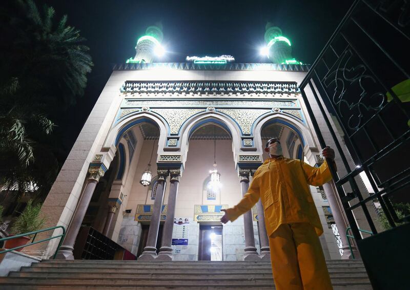 A worker opens Salah El Din mosque's door for prayers, first prayers of Al-Fajr prayer after months of lockdown in Cairo, Egypt. Reuters