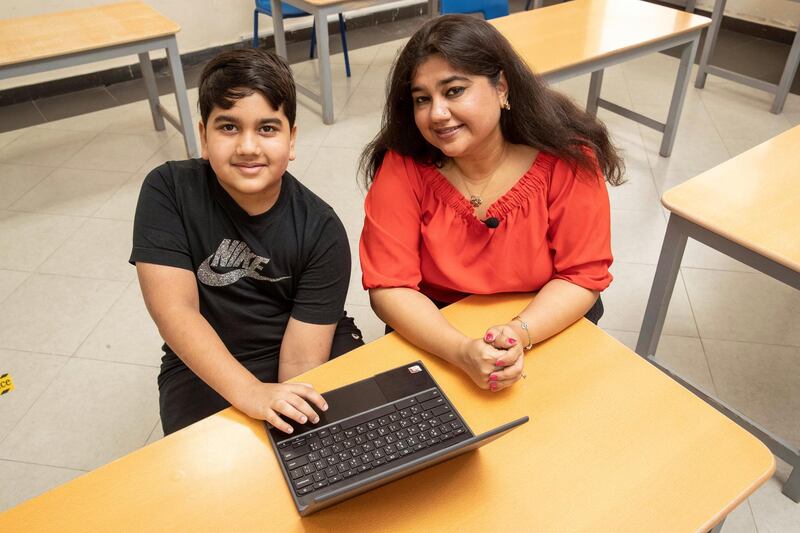 RAS AL KHAIMAH, UNITED ARAB EMIRATES. 28 OCTOBER 2020. RAK Academy International Secondary School-ISK has provided students with Chrome Book laptops to aid in their studies. 5th Grade student Advay Roy Sarkar with his Chrome Book along with is mother Cheshta Roy Sarkar. (Photo: Antonie Robertson/The National) Journalist: Ruba Haza. Section: National.
