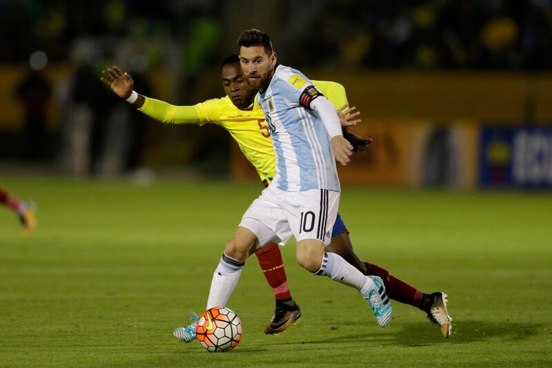 Lionel Messi fights for the ball against Ecuador's Alex Ibarra. Dolores Ochoa / AP Photo