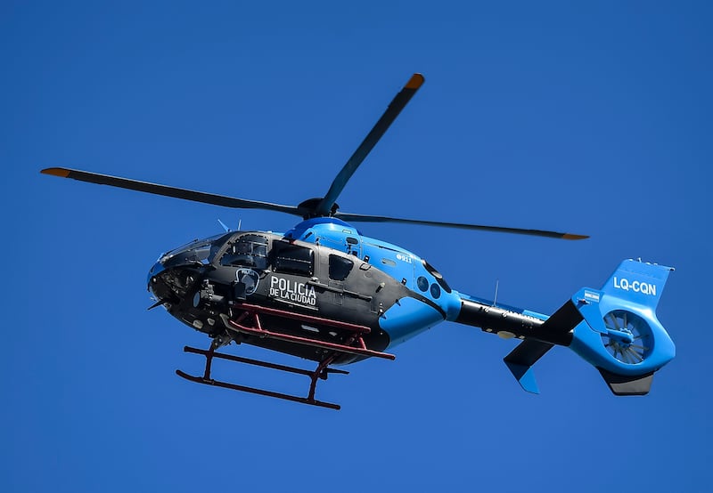 A helicopter of the Buenos Aires city police force carries Lionel Messi and Lionel Scaloni over the parade. Getty
