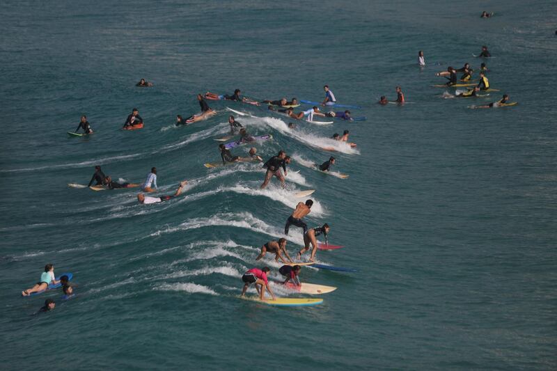 People take surfing lessons in Arpoador beach in Rio de Janeiro on Friday, March 26. Reuters