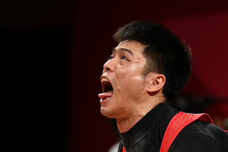 China's Li Fabin on his way to victory in the Men's 61kg Weightlifting.