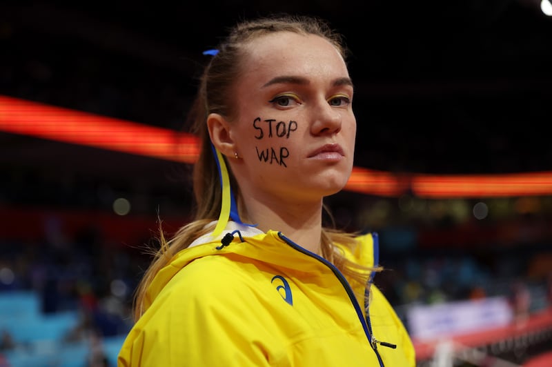 Yana Hladiychuk of Ukraine UKR looks on with a 'Stop War' message on her face after the women's pole vault on day two of the World Athletics Indoor Championships Belgrade 2022 on March 19. Getty Images