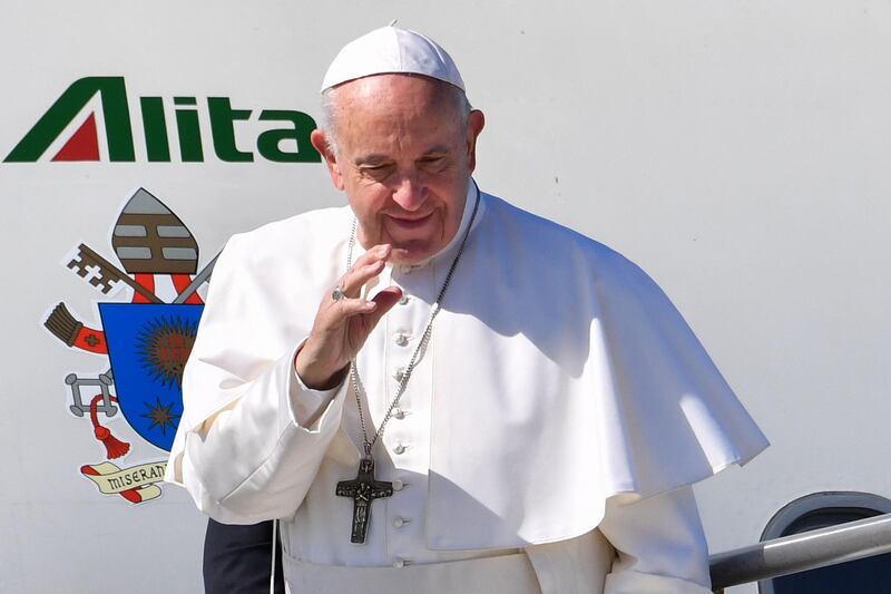 Pope Francis waves as he boards a plane upon his departure for a two-day trip to Morocco. AFP