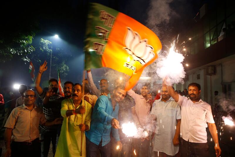 Supporters of India's ruling Bharatiya Janata Party (BJP) light firecrackers and celebrate the government revoking Kashmir's special status, in Lucknow, India.  AP