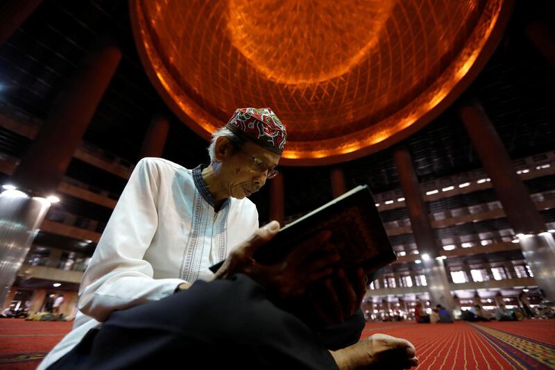Indonesian Muslim man reads the Quran as he waits for iftar during Ramadan at Istiqlal mosque in Jakarta, Indonesia. Reuters