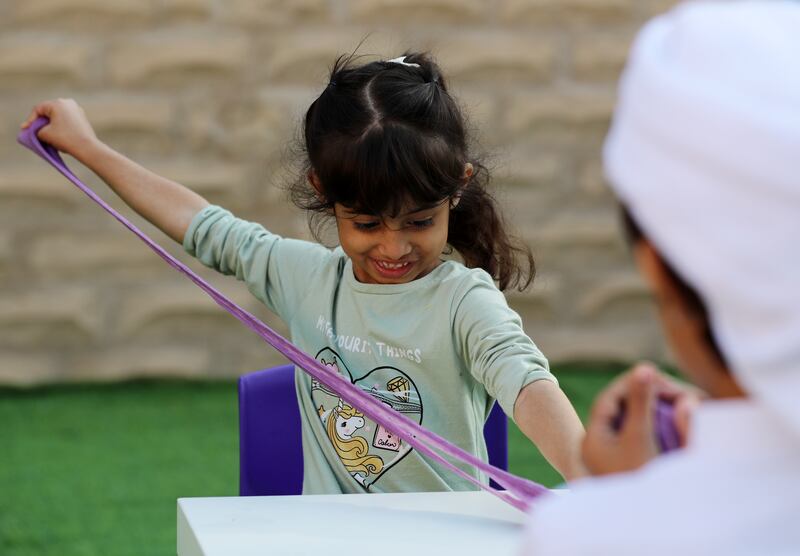 Raya, aged 4, plays with slime