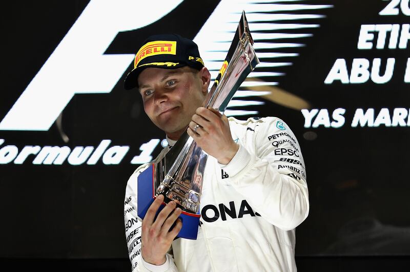 ABU DHABI, UNITED ARAB EMIRATES - NOVEMBER 26:  Race winner Valtteri Bottas of Finland and Mercedes GP celebrates on the podium during the Abu Dhabi Formula One Grand Prix at Yas Marina Circuit on November 26, 2017 in Abu Dhabi, United Arab Emirates.  (Photo by Mark Thompson/Getty Images)