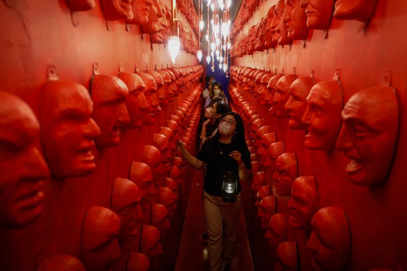 Visitors come face to face with spooky masks at Whimsical Wonderland in Quezon City, Philippines. EPA