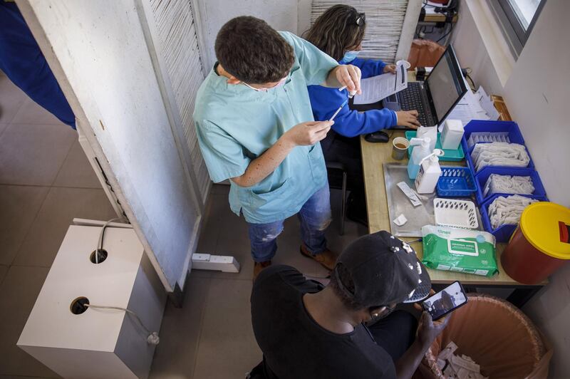 A nurse prepares a dose of the Pfizer-BioNTech Covid-19 vaccine for administration to a foreign national at a vaccination centre in Tel Aviv. Bloomberg