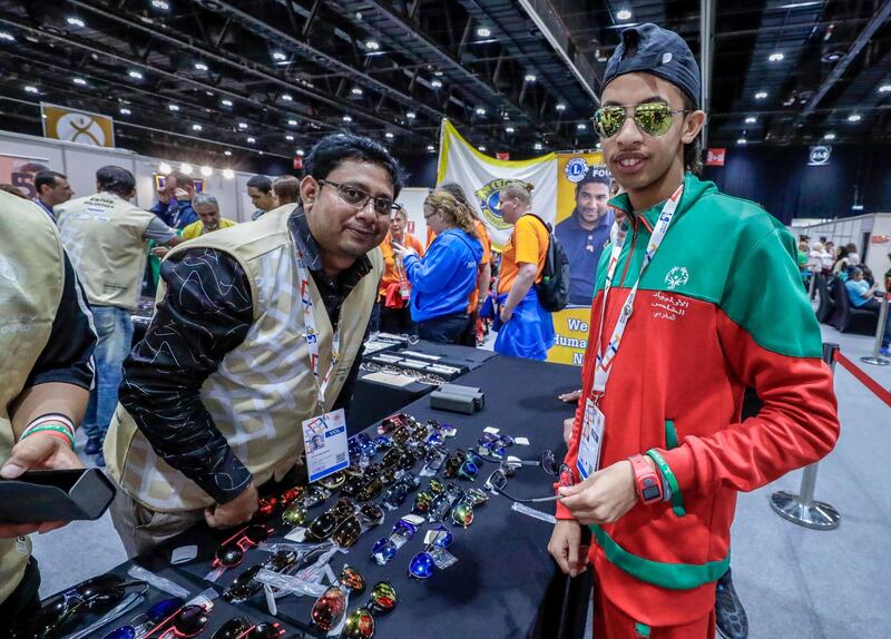 Abu Dhabi, March 17, 2019.  Special Olympics World Games Abu Dhabi 2019. At the Healthy Athletes area at ADNEC.  This is an area where the special athletes may get free medical check ups and enjoy other health activities. --  Bouyi Ilyas picks out a fre pair of sunglasses.
Victor Besa/The National
