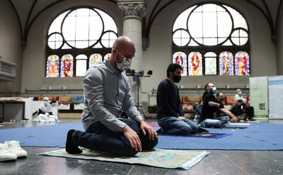 Muslims pray inside the evangelical church of St. Martha's parish, during their Friday prayers, as the community mosque can't fit everybody in due to social distancing rules, amid the coronavirus disease (COVID-19) outbreak in Berlin, Germany, May 22, 2020.   REUTERS/Fabrizio Bensch