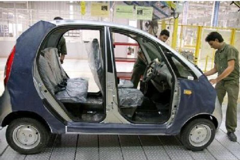 Employees of Tata Motors work on a Nano. India is now the world's seventh-largest vehicle producer, six years ahead of the government's target date for the goal.