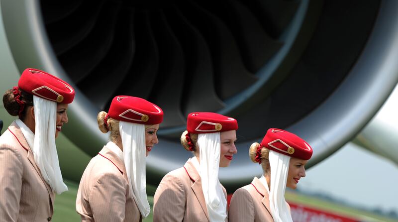 Stewardesses pose in front of an Emirates Airlines A380 aircraft. AFP