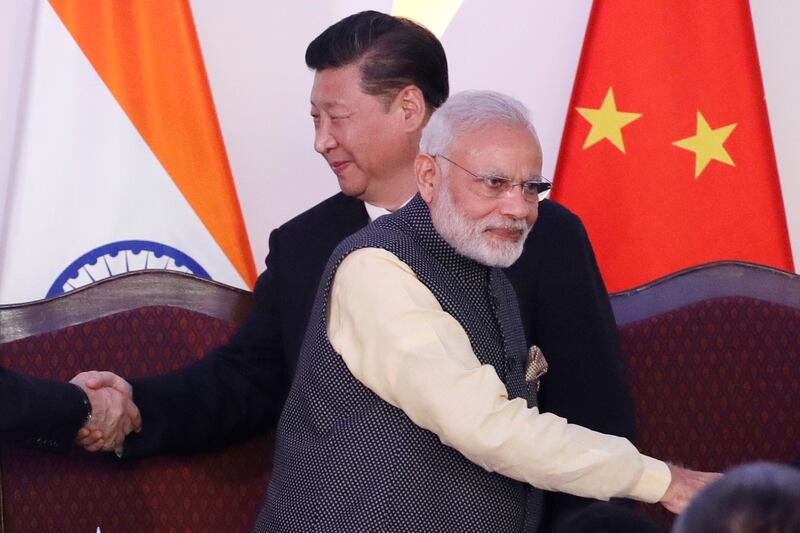 Indian Prime Minister Narendra Modi, front and Chinese President Xi Jinping shake hands with leaders at the Brics summit in Goa, India on October 16, 2016. The relationship between India and China has become far more openly competitive over the past decade. AP