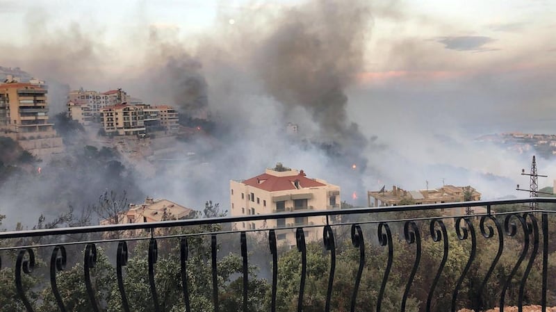A view of the wildfire from a balcony. Image Lebanon Civil Defence via Twitter