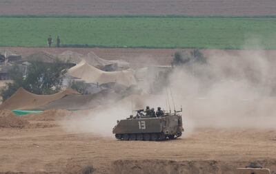 Israeli soldiers in an armoured personnel carrier near Gaza. Reuters