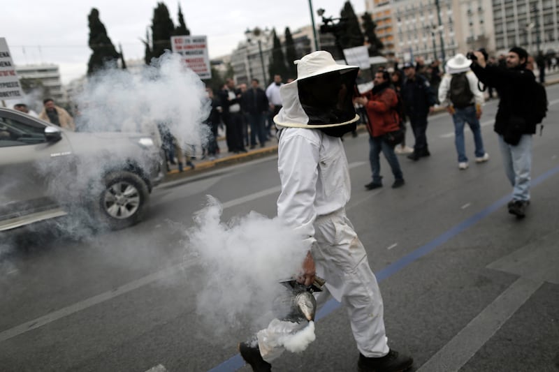 A beekeeper at a rally of beekeepers outside the Greek parliament building in Athens, Greece. EPA