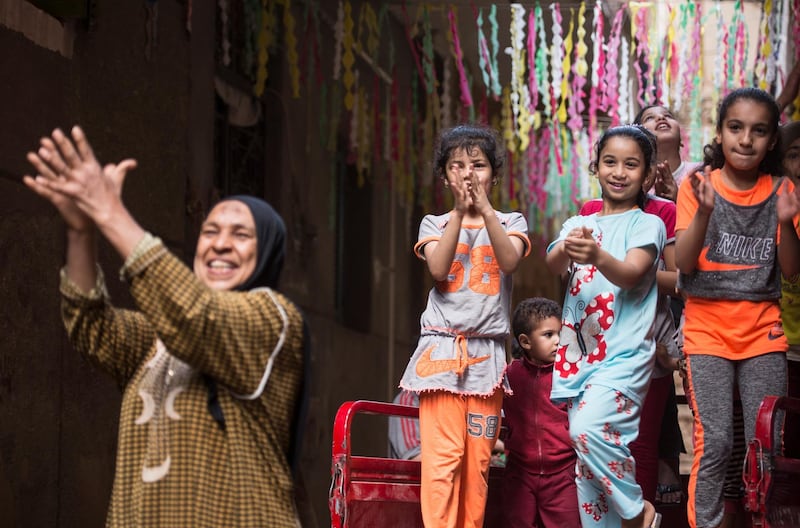 Children react to the installation of Ramadan ornaments at the streets of Giza, Egypt, 20 April 2020. EPA