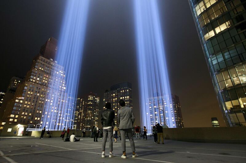 People observe the 'Tribute in Light' atop the Battery Parking Garage. AFP