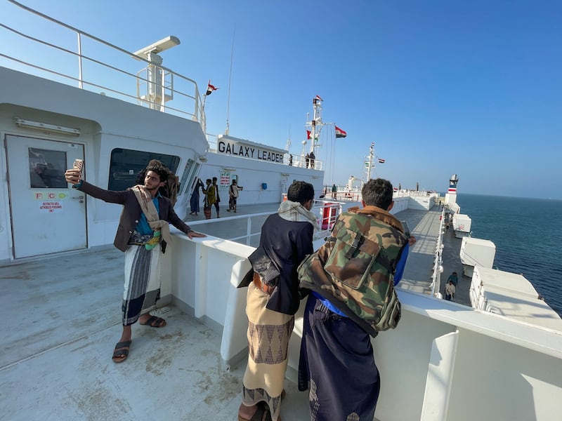 People tour the deck of the Galaxy Leader commercial ship, seized by Yemen's Houthis last month, off the coast of al-Salif, Yemen.  Reuters
