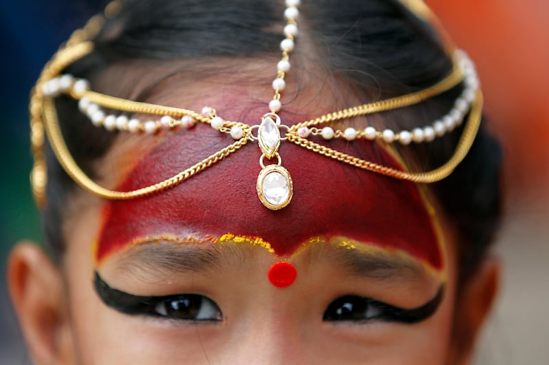 A young Nepalese  girl dressed as living goddess Kumari waits for Kumari Puja to start at Basantapur Durbar Square in Kathmandu. Niranjan Shrestha / AP Photo