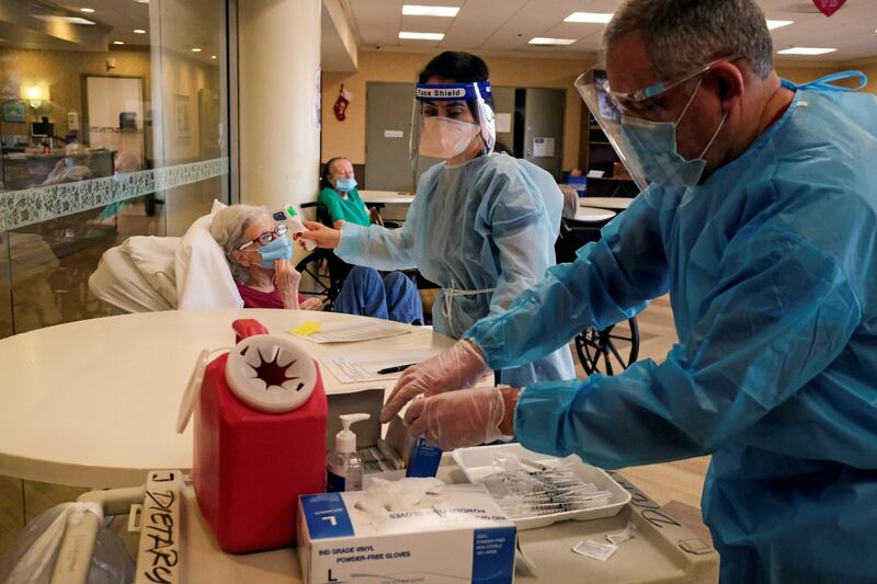 A resident at Hamilton Park Nursing and Rehabilitation, a nursing home facility, receives the Pfizer-BioNTech coronavirus disease (COVID-19) vaccine from Walgreens Pharmacists in Brooklyn, New York, U.S., January 4, 2021. REUTERS/Yuki Iwamura