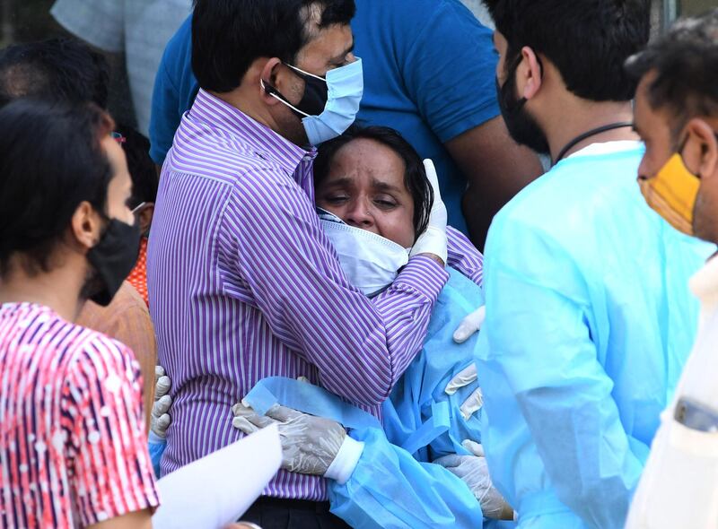 Relatives mourn during the last rites of a Covid-19 victim at a crematorium in New Delhi, India. EPA