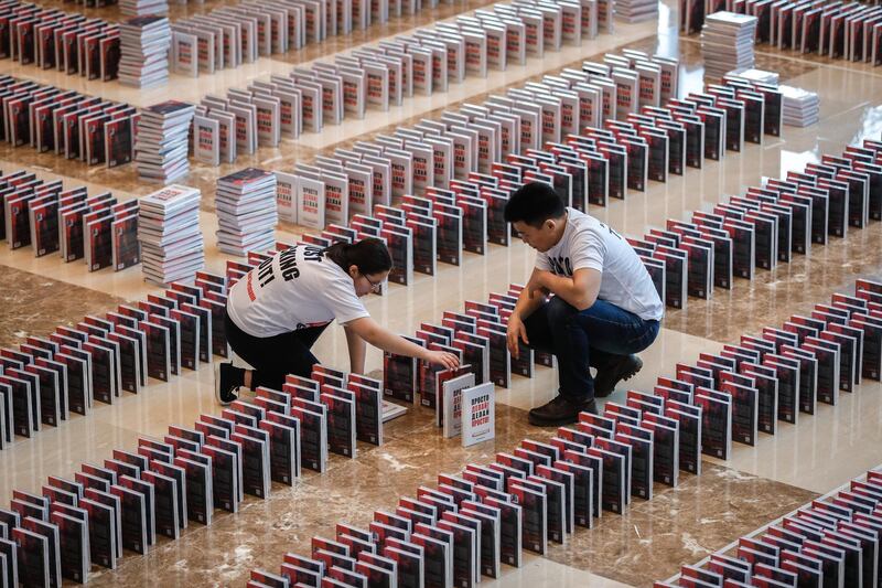 People install a domino books titled 'Just do it! Do it easy!' by German-Russian businessman Oskar Hartmann prior to attempt to set the book dominoes world record in Moscow, Russia.  EPA