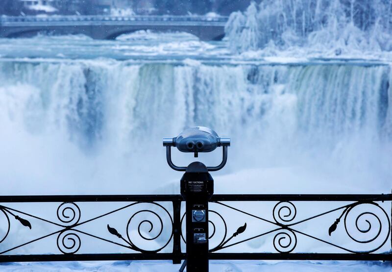 A pair of binoculars looks over ice forming at the base of the American Falls.  Aaron Lynett / The Canadian Press via AP
