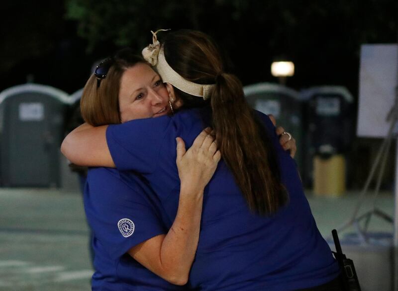 Gilroy Garlic festival volunteer Denise Buessing, left, embraces fellow volunteer Marsha Struzik after the shooting. AP