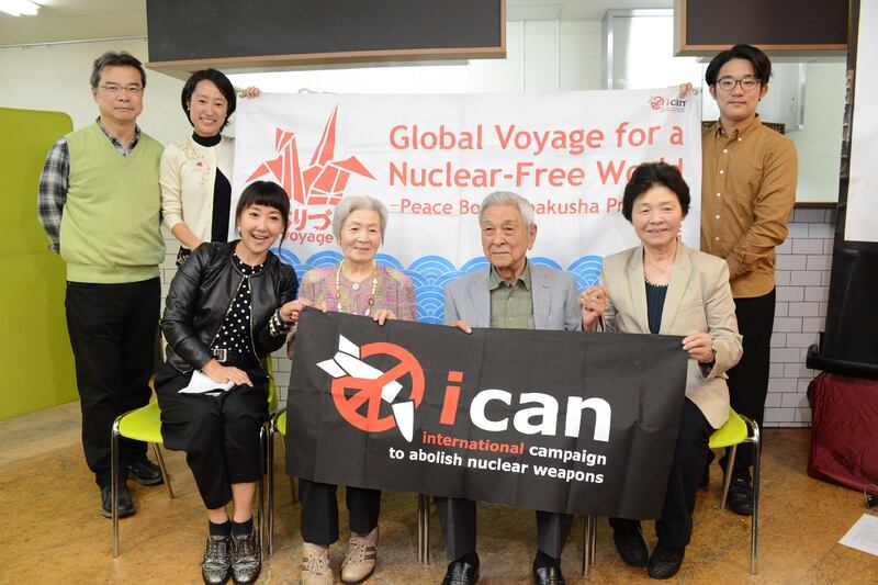 Three Japanese survivors of the atomic bomb (front 2nd L, 2nd R and R) pose with their supporters to congratulate ICAN on winning this year's Nobel Peace Prize, in Tokyo on October 6, 2017. / AFP PHOTO / JIJI PRESS / STR / Japan OUT
