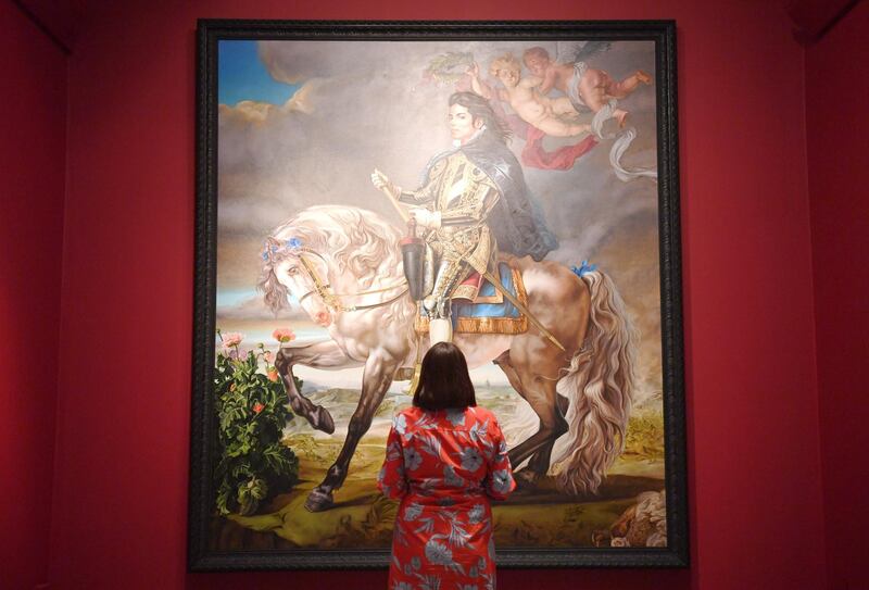 A woman poses near US painter Kehinde Wiley's "Equestrian Portrait of King Philip II (Michael Jackson)" during a press preview of the exhibition "Michael Jackson: On the Wall" at the National Portrait Gallery in London, Britain, on June 27, 2018.Neil Halll / EPA