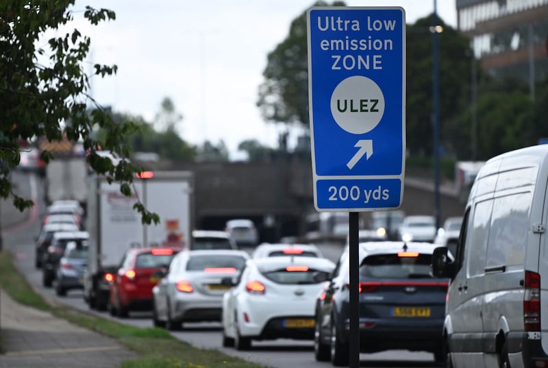Traffic passes a sign pointing to the ultra-low emission zone near Hanger Lane in west London on July 22. AFP